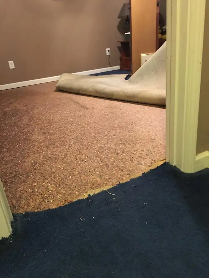 Carpet pad removal revealing water damage during Water Mitigation Services in Fontana